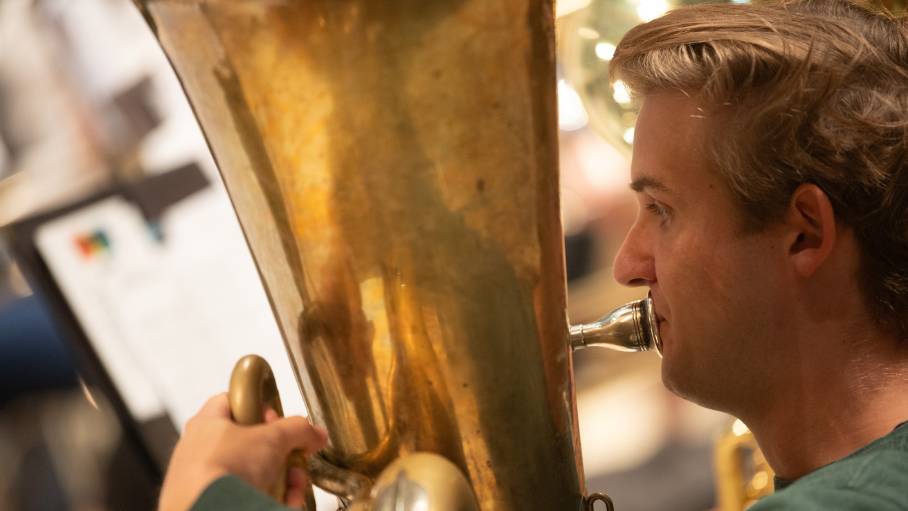 close up photo of man playing the Tuba